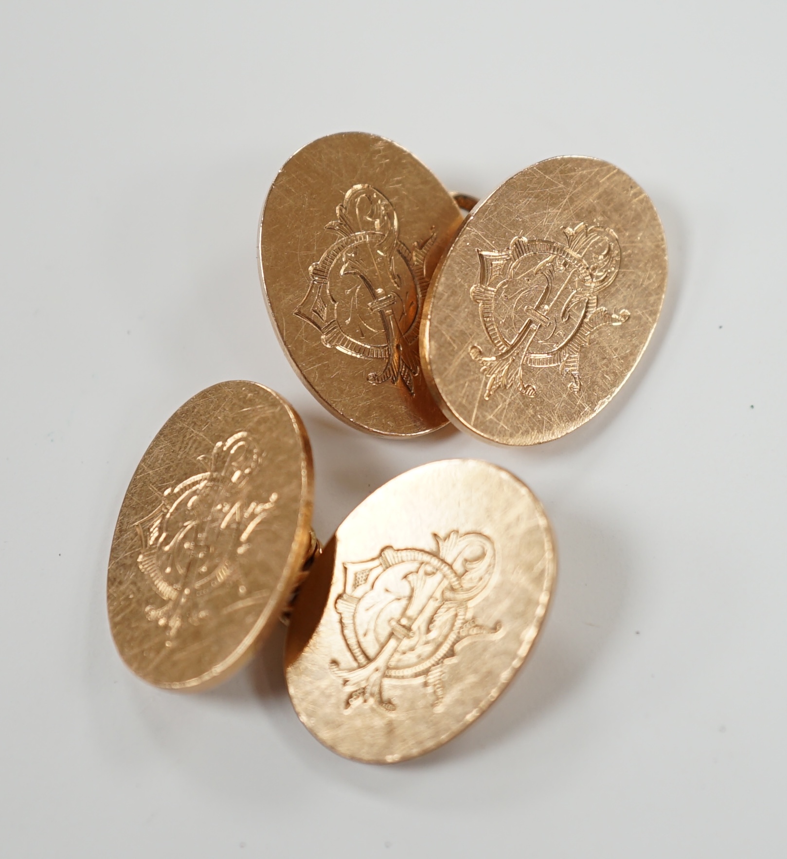 A pair of George V 9ct gold oval cufflinks, with engraved monogram